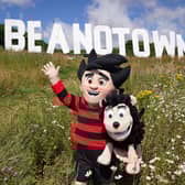 Dennis the Menace stands in front of a giant sign erected at Dundee Law renaming the city of Dundee to Beanotown to mark the start of the Dundee Bash Street Festival, which celebrates the city's comic book heritage. Designers have taken their inspiration from the famous Hollywood sign, the sign is six-metres high by 38-metres long and will be seen from around the city and across the Tay for the duration of the festival. Picture date: Friday July 15, 2022.