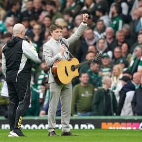 Scottish singer Daniel Rooney (right) playing at half time during the cinch Premiership match at Celtic Park. He was called up as a last-minute replacement for Olly Murs on Friday night. Picture: Andrew Milligan/PA Wire