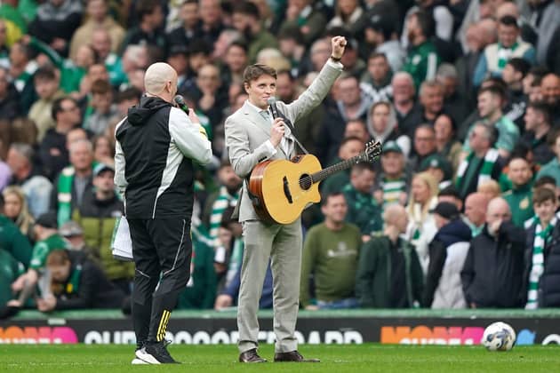 Scottish singer Daniel Rooney (right) playing at half time during the cinch Premiership match at Celtic Park. He was called up as a last-minute replacement for Olly Murs on Friday night. Picture: Andrew Milligan/PA Wire