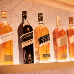 FTSE-100 spirits giant Diageo has a vast portfolio that includes Johnnie Walker whisky, pictured. The group has almost 30 malt distilleries in Scotland.