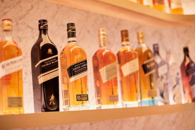 FTSE-100 spirits giant Diageo has a vast portfolio that includes Johnnie Walker whisky, pictured. The group has almost 30 malt distilleries in Scotland.