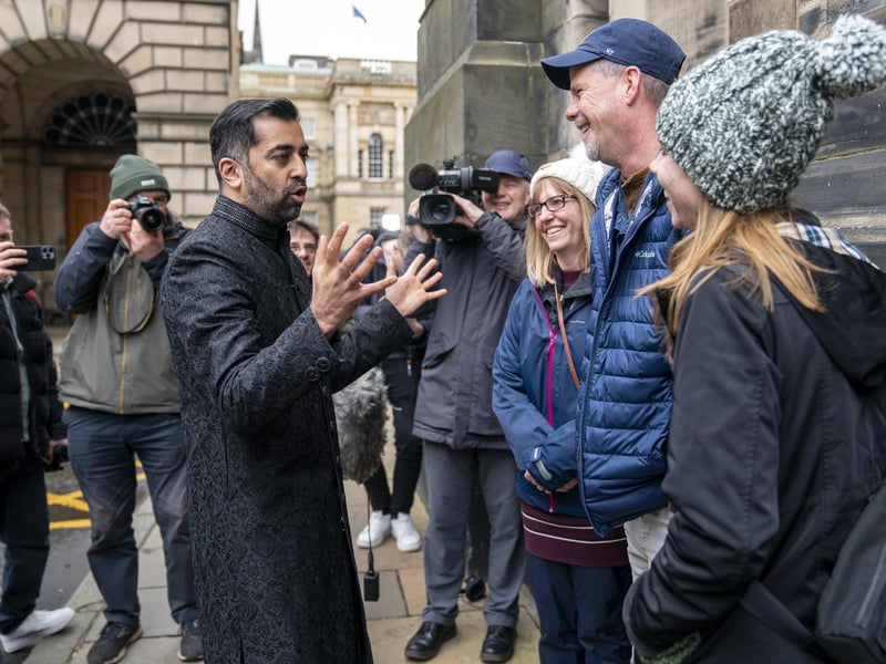 Humza Yousaf speaks with members of the public outside the Court of Session in Edinburgh after being sworn in as First Minister of Scotland.