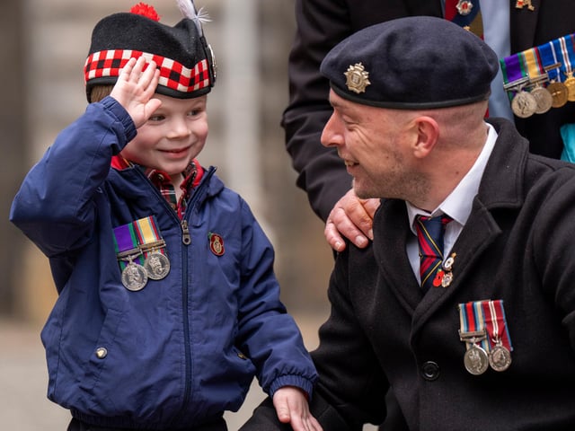 Lance Corporal David Clyde with his son Matthew Clyde, 5, after the Remembrance Sunday ceremony at the Stone of Remembrance outside the City Chambers in Edinburgh.