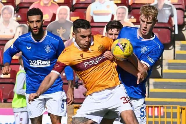 Connor Goldson watches as Motherwell's Tony Watt (left) battles with Rangers' Filip Helander (Photo by Rob Casey / SNS Group)