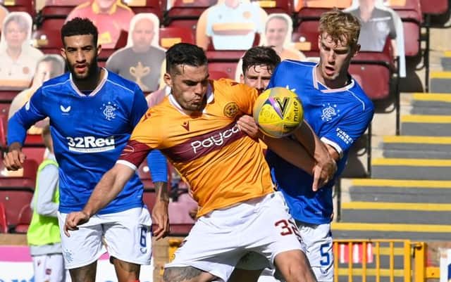 Connor Goldson watches as Motherwell's Tony Watt (left) battles with Rangers' Filip Helander (Photo by Rob Casey / SNS Group)