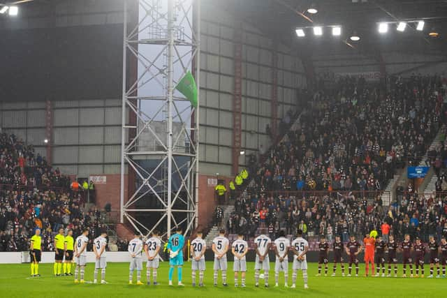 Both sides observe what proved a disrupted minute's silence at the start of the second half of Hearts v Istanbul Basaksehir. The Queen's death was announced at half-time of the Europa Conference League clash (Photo by Paul Devlin / SNS Group)