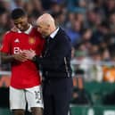 Erik ten Hag, Manager of Manchester United, speaks with his player Marcus Rashford during the UEFA Europa League round of 16 leg two match between Real Betis and Manchester United at Estadio Benito Villamarin on March 16, 2023 in Seville, Spain. (Photo by Fran Santiago/Getty Images)