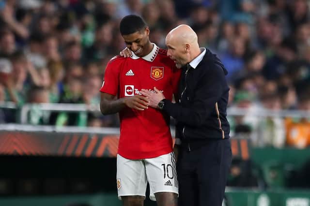 Erik ten Hag, Manager of Manchester United, speaks with his player Marcus Rashford during the UEFA Europa League round of 16 leg two match between Real Betis and Manchester United at Estadio Benito Villamarin on March 16, 2023 in Seville, Spain. (Photo by Fran Santiago/Getty Images)