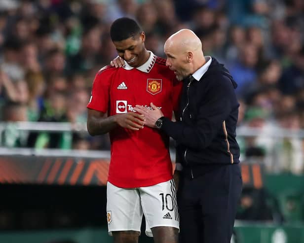 Erik ten Hag, Manager of Manchester United, speaks with his player Marcus Rashford during the UEFA Europa League round of 16 leg two match between Real Betis and Manchester United at Estadio Benito Villamarin on March 16, 2023 in Seville, Spain. (Photo by Fran Santiago/Getty Images)