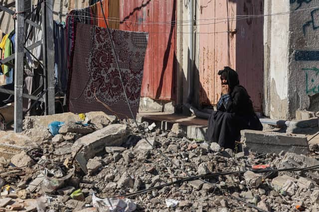 A woman looks at the rubble of buildings destroyed by Israeli bombing in Rafah in the southern Gaza Strip (Photo by Mohammed ABED / AFP) (Photo by MOHAMMED ABED/AFP via Getty Images)