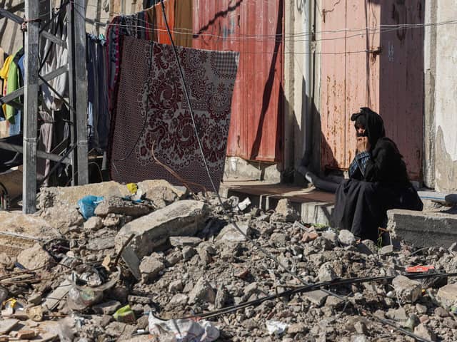 A woman looks at the rubble of buildings destroyed by Israeli bombing in Rafah in the southern Gaza Strip (Photo by Mohammed ABED / AFP) (Photo by MOHAMMED ABED/AFP via Getty Images)