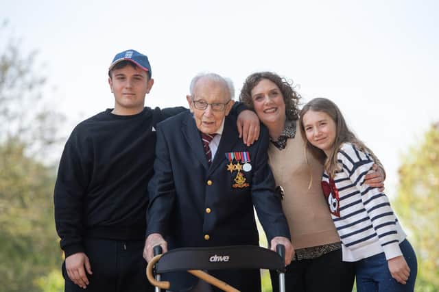 Captain Tom poses with (left to right) his grandson Benji, daughter Hannah Ingram-Moore and granddaughter Georgia at his home in Marston Moretaine in Bedfordshire