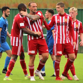 Jonny Smith is congratulated by Julian Wade and Johnny Crawford after scoring the 4th goal (penalty)