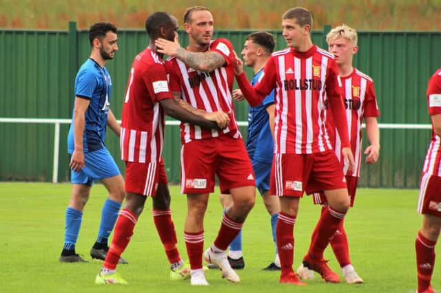 Jonny Smith is congratulated by Julian Wade and Johnny Crawford after scoring the 4th goal (penalty)