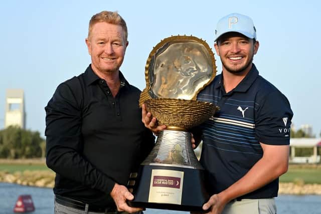 Top swing coach Jamie Gough holds the  Commercial Bank Qatar Masters with Ewen Ferguson after the Scot's weekend win at Doha Golf Club. Picirure: Stuart Franklin/Getty Images.