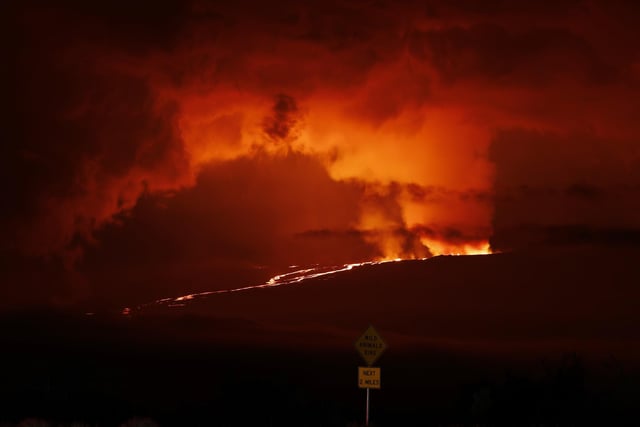 A river of lava flows down from Mauna Loa, Monday, Nov. 28, 2022, near Hilo, Hawaii. Mauna Loa, the world's largest active volcano erupted Monday