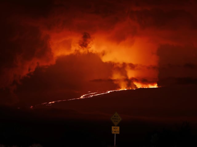 A river of lava flows down from Mauna Loa, Monday, Nov. 28, 2022, near Hilo, Hawaii. Mauna Loa, the world's largest active volcano erupted Monday