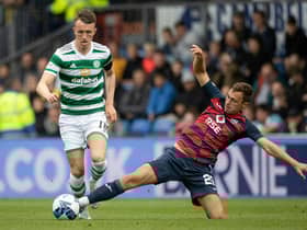 Connor Randall tackles Celtic's David Turnbull - but it was a later challenge on Jota that resulted in a fractured leg for the Ross County player.  (Photo by Craig Williamson / SNS Group)