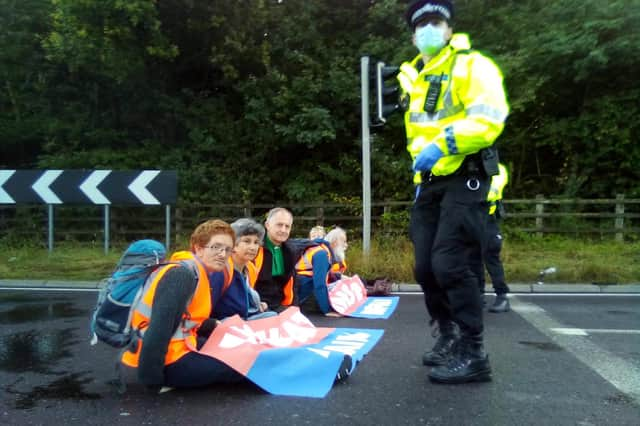 Handout photo issued by Insulate Britain of protesters from Insulate Britain blocking a roundabout at Junction 3 of the M25.