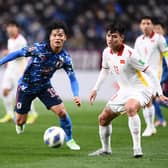 Celtic midfielder Reo Hatate fights for possession on his Japan debut against Vietnam.