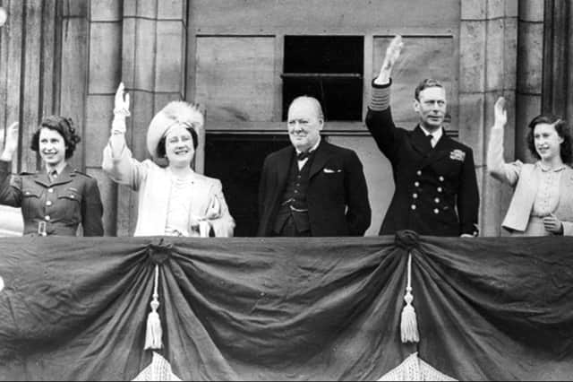 Winston Churchill, centre, joins the royal family, from left, Princess Elizabeth, Queen Elizabeth, King George VI, and Princess Margaret, on the balcony of Buckingham Palace to celebrate VE Da (Picture: AP)
