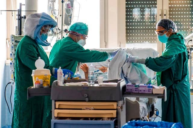 Medical workers tend to a patient at the Intensive Care Unit of the Tor Vergata Covid-4 hospital on April 21, 2020 in Rome. Photo by ANDREAS SOLARO/AFP via Getty Images