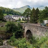 KILLIN, SCOTLAND The historic stone bridge of the A827 road above the river and falls of  Dochart in Killin, Scotland. Copyright (c) 2020 Mino Surkala/Shutterstock.