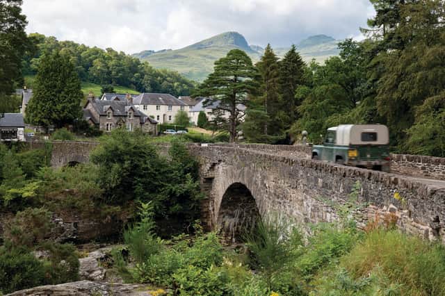 KILLIN, SCOTLAND The historic stone bridge of the A827 road above the river and falls of Dochart in Killin, Scotland. Copyright (c) 2020 Mino Surkala/Shutterstock.