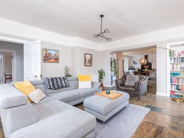 The sitting room is fitted with a wood burning stove and has doors leading onto a sun deck.