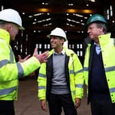 Rishi Sunak and Scotland Secretary Alister Jack, in the green hat, visit the Port of Cromarty Firth earlier this year (Picture: Russell Cheyne/pool/AFP via Getty Images)