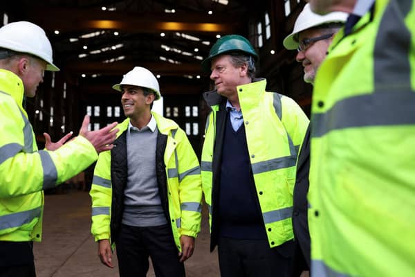 Rishi Sunak and Scotland Secretary Alister Jack, in the green hat, visit the Port of Cromarty Firth earlier this year (Picture: Russell Cheyne/pool/AFP via Getty Images)