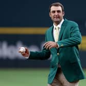 Dallas-based Scottie Scheffler wore his Green Jacket to throw out the ceremonial first pitch before the Texas Rangers took on  the Houston Astros at Globe Life Field soon after his Masters win last April. Tom Pennington/Getty Images.