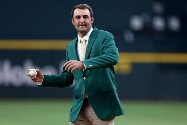 Dallas-based Scottie Scheffler wore his Green Jacket to throw out the ceremonial first pitch before the Texas Rangers took on the Houston Astros at Globe Life Field soon after his Masters win last April. Tom Pennington/Getty Images.