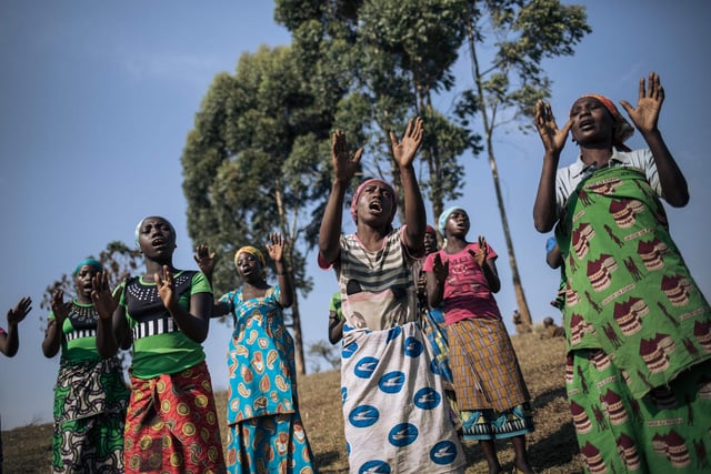 Displaced women from the Bafuliru community pray near the internally displaced persons camp of Bijombo, South Kivu Province, eastern Democratic Republic of Congo.