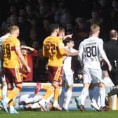 Motherwell's Bevis Mugabi (R) is sent off by referee Willie Collum.