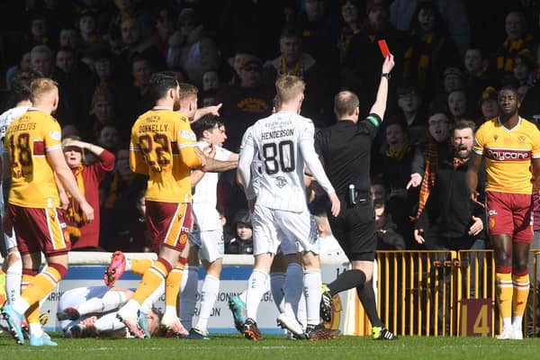 Motherwell's Bevis Mugabi (R) is sent off by referee Willie Collum.