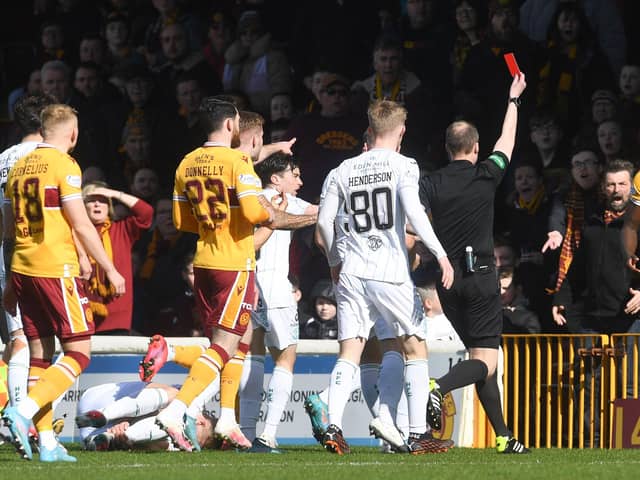 Motherwell's Bevis Mugabi (R) is sent off by referee Willie Collum.