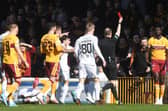 Motherwell's Bevis Mugabi (R) is sent off by referee Willie Collum.