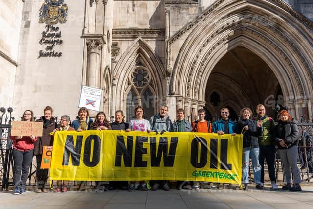Environmental campaigners stage a protest outside the High Court in London, warning against new oil and gas drilling in UK waters