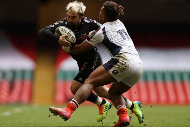 Jordan Williams of Dragons is tackled by Edinburgh's Eroni Sau. Picture: Chris Fairweather/Huw Evans/Shutterstock