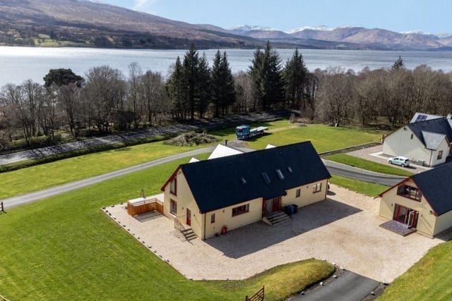 Aerial view of property and views across Loch Eil and distant mountains.