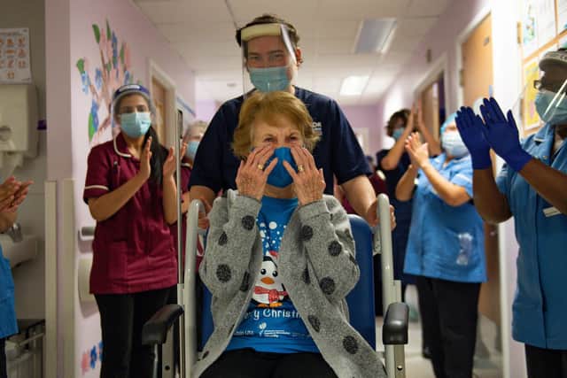 Margaret Keenan, 90, is applauded by staff as she returns to her ward after becoming the first person in the United Kingdom to receive the Pfizer/BioNtech covid-19 vaccine at University Hospital, Coventry.