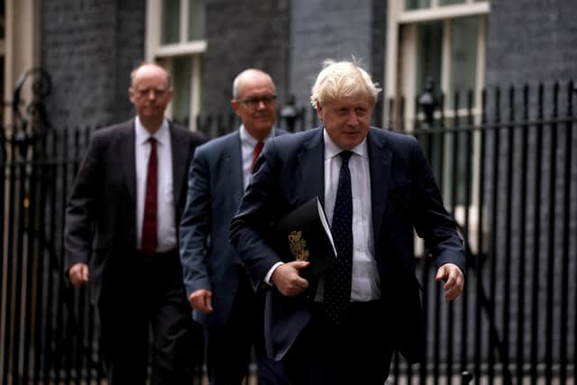 Britain's Chief Medical Officer for England Chris Whitty (left), Britain's Prime Minister Boris Johnson (right) and Britain's Chief Scientific Adviser Patrick Vallance (centre) walk towards the door of No.9 Downing Street. Picture: Dan Kitwood-WPA Pool/Getty Images