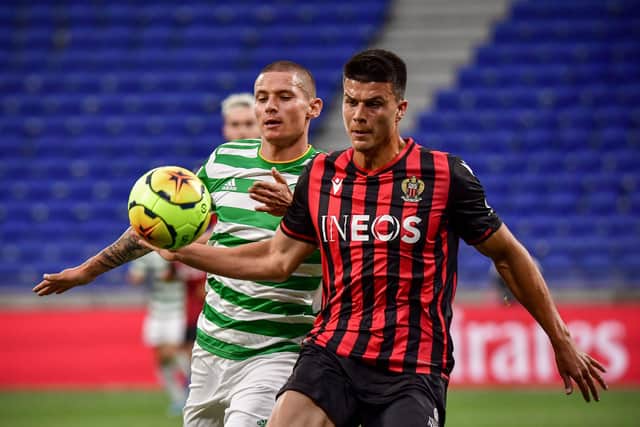 Celtic striker Patryk Klimala gets up close to Nice defender Flavius Daniliuc. Picture: AFP via Getty Images