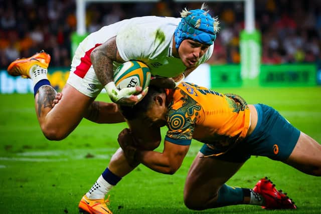 England's Jack Nowell tries to find a way past Australia's Hunter Paisami at Suncorp Stadium. (Photo by Patrick HAMILTON / AFP)