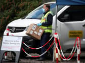 Staff from the Scottish Ambulance Service carry boxes of test kits from a van at a Covid Mobile Testing Unit in a car park in the Pollokshields area of Glasgow. Glasgow and Moray remain in Level 3 restrictions despite the rest of mainland Scotland moving to Level 2 on Monday. Picture date: Tuesday May 18, 2021.