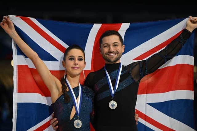 Britain's Lilah Fear and Lewis Gibson pose with a flag during the victory ceremony after the Ice Dance event of the ISU European Figure Skating Championships in Espoo, Finland.