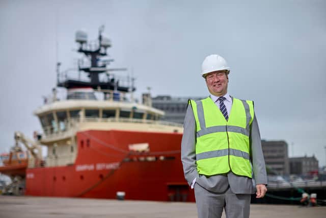 North Star Renewables director Andrew Duncan quayside in front of one the firm’s D-class vessels with existing twin daughter craft. Picture: Ross Johnston/Newsline Media