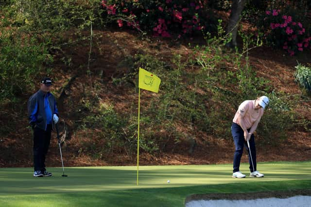 Bob MacIntyre on the 12th green as Sandy Lyle of Scotland looks on during a practice round prior to the 2022 Masters at Augusta National Golf Club. Picture: David Cannon/Getty Images.