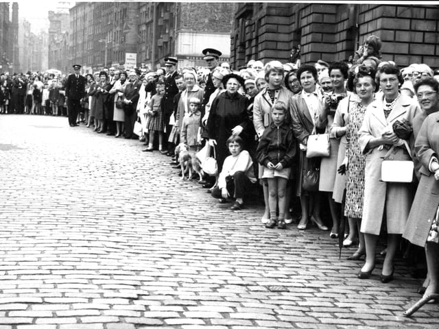 A crowd of several hundred line the High Street from the City Chambers to St Giles Cathedral to watch the traditional procession to mark the opening of the Edinburgh International Festival in 1962.